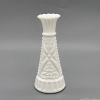 Front view of white pressed milk glass vase showing starburst pattern