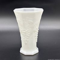Full view of white milk glass octagonal vase showing grape motif and overall shape
