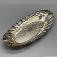 Full angled view of oval silver-plated tray showing overall design and tarnish
