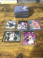 Stack of sleeved cards with five feature cards displayed