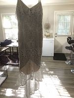 Front view of lace mermaid high-low dress hanging