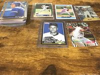 Overall lot showing stack of cards and several notable sleeved cards