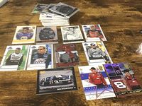 Stacked and laid-out NASCAR trading cards showing various drivers and designs