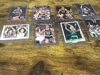All eight Larry Bird cards displayed in top loaders