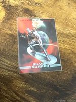 Front view of sleeved Silver Surfer card