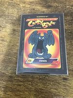 Front view of sleeved Fangs sticker card showing artwork and card number
