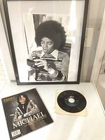 Lot overview showing framed photo, magazine and vinyl single