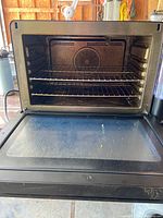 Front view with door open showing rack and fan