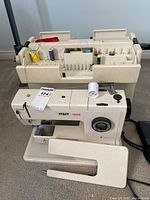 Pfaff 1222E sewing machine with case, organizer tray, accessories and foot pedal visible