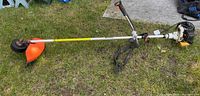 Full view of Stihl FS106 brush cutter with harness strap attached