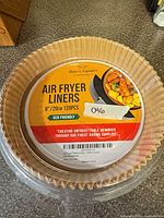 Top view of sealed stack of 8 in paper air fryer liners with label showing brand, size and quantity