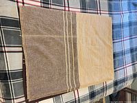 Blanket folded showing beige and brown colour blocks with cream stripes