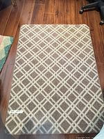 Top view of rectangular brown and beige lattice rug