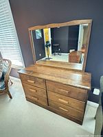 Front view of dresser with mirror attached showing overall design and finish