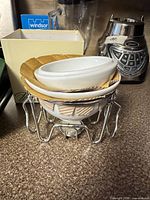Set stacked together showing ceramic bowls inside chrome stand