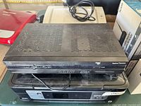 Top and front view of Cisco Explorer 4642HD sitting on other equipment