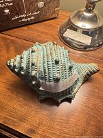 Top view of turquoise resin conch shell with bronze accents