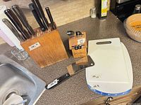 Overall lot with large knife block, small Cutco block, cleaver, cutting boards
