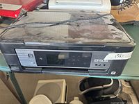Front view of Epson XP-410 printer showing control panel and sticker