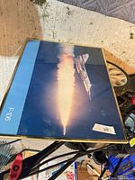 Front view of framed F-106 aircraft print showing image, gold frame, landscape orientation