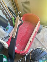 Overview of red wagon showing wooden rails and black handle