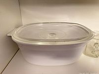 White oval CorningWare casserole with lid