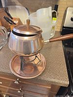 Overall view of fondue pot on stand