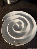 Top view of white ceramic spiral chip and dip bowl