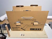 Original cardboard box labelled Cordless Power Scrubber