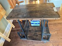 Top and full view of end table showing wood surface, metal frame, casters