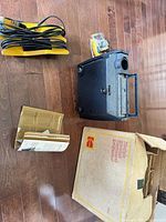Projector, power cord, accessory pack, manual, box on floor