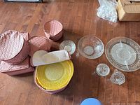Group of glass pieces and pink storage cases on floor