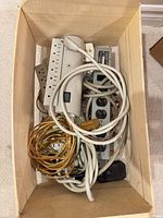Top view of crate with cords and power strips visible