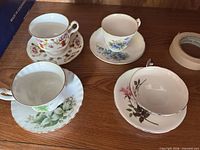 All four teacup and saucer sets displayed