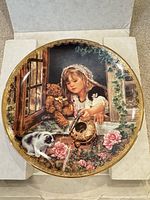 Front of decorative plate showing detailed scene and gold rim