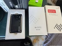 Device seated in inner packaging next to box lid