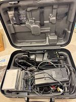 Camcorder, AC adapter, tapes, cables and battery in hard case