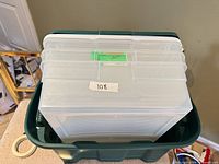 Top view showing three clear organizer boxes stacked inside green tote