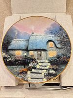 Front view of Candlelit Cottage collector plate inside box