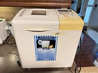 Front and side view of Toastmaster bread maker showing brand label and discoloration