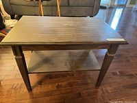 Full view of coffee table front and shelf