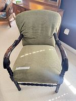 Front view of olive green upholstered accent armchair
