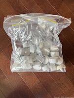Bag of numerous white plastic LED tealight candles