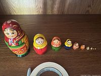 Full lineup of eight visible dolls showing size gradation and paint details