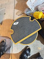 Top view of circular black rubber tread on upper step showing label 149