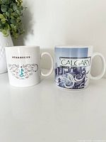 Front view showing designs of both mugs