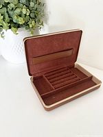 case open showing velvet interior with compartments and ring slots
