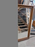Full view of mirror with wooden frame