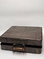 Top and side view of flat steel ammo box showing wooden handle and patina