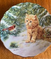 Front view showing kitten, cardinal, gold rim